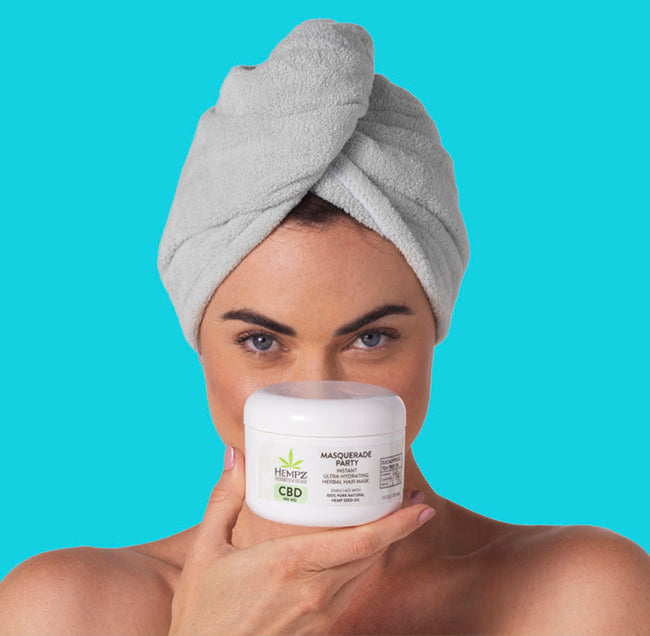 Model with hair in turban holding CBD Masquerade Party CBD Herbal Mask